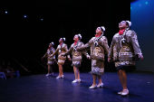 UCSC mainstage line of performers dancing the region of Tamaulipas Huasteca in the traditional brown leather jacket and skirts